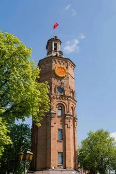 Old clock tower with weathered brick and clock face Stock Photos