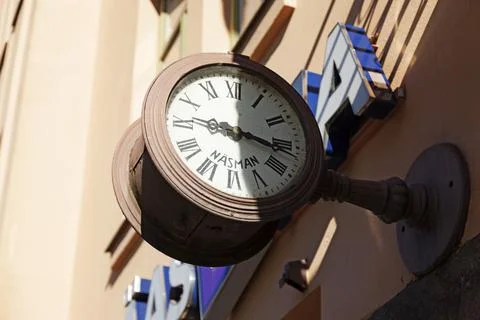 An old clock with an unusual mark above a store Stock Photos