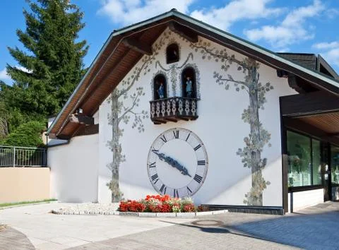 Old clock on the wall of the house Stock Photos