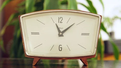 Old clock with white dial close-up. Vintage table clock on table on room Stock Footage 99404104