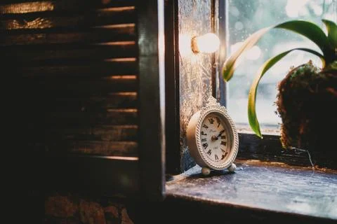Old clock on the window Stock Photos