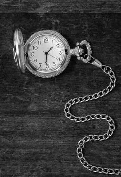 The old clock on a wooden surface Stock Photos
