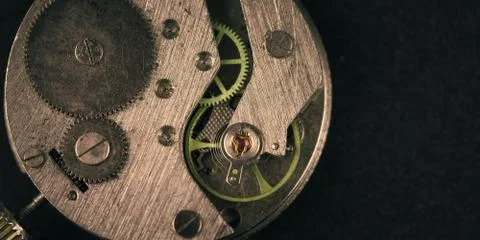 Old clockwork mechanism in close-up. Selective focus on macro details. Light  Stock Photos