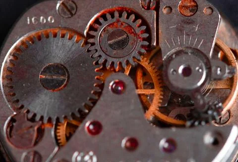 Old clockwork mechanism in close-up. Selective focus on macro details. Light  Stock Photos