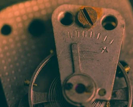 Old clockwork mechanism in close-up. Selective focus on macro details. Light  Stock Photos