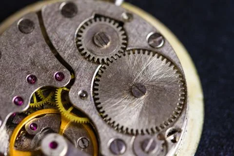 Old clockwork mechanism in close-up. Selective focus on macro details. Light  Stock Photos