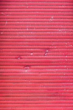 A old closed broken red roller shutter Stock Photos