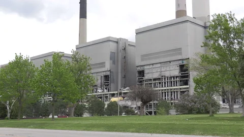 Old coal powered electrical power generating station being torn down Stock Footage 153963342
