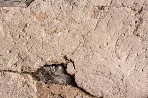 Old cob wall with cracked surface Stock Photos