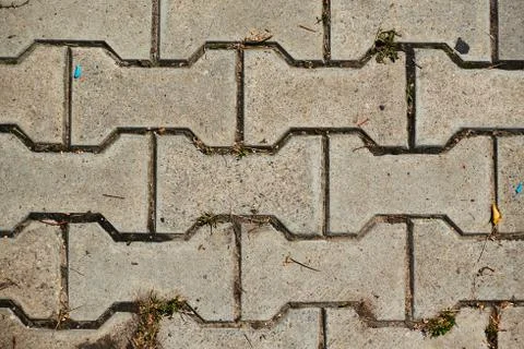 Old cobblestone background with grass. The view from the top 写真素材