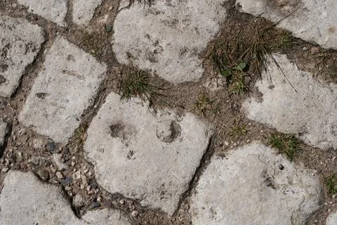 Old cobblestone background with grass. The view from the top Stock Photos