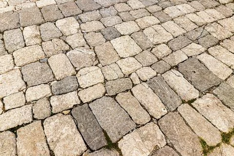 Old cobblestone pavement texture. Ancient sidewalk background. Stock Photos