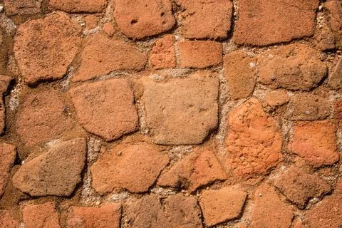 Old cobblestone road with soil between stones. Texture and background. Stock Photos