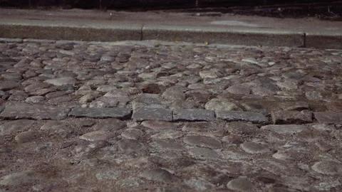 Old cobblestone road on which vehicles move Video stock 163579135