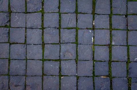 Old cobblestone tile texture in old town. City pavement background Stock Photos