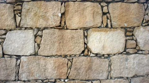 Old Cobblestone wall. Background and textures photography. Stock Photos