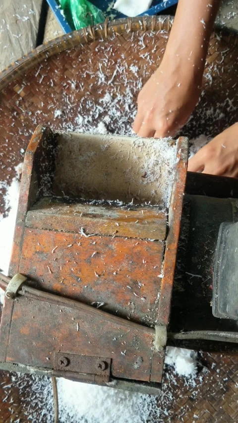 Old coconut grinding machine to make coconut milk Stock Footage 306269812