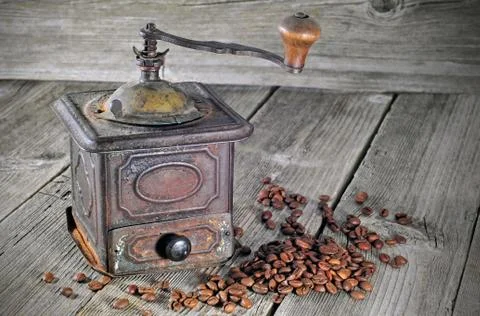 Old coffee grinder with coffee beans Stock Photos