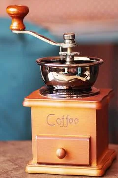 An old coffee grinder is on the table Stock Photos