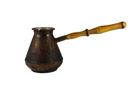 The old coffee maker out of copper with a wooden handle. Stock Photos