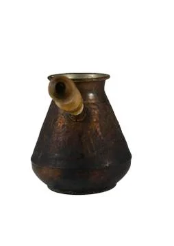 The old coffee maker out of copper with a wooden handle. Stock Photos