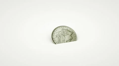 An old coin falls, starts to spin very quickly and stops. Video stock 129809113