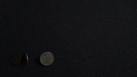 Old coins falling on black mat in slow motion Stock Footage 221877616