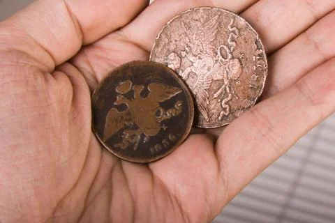 Old coins in hand Stock Photos