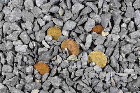 Old coins in pebbles Stock Photos