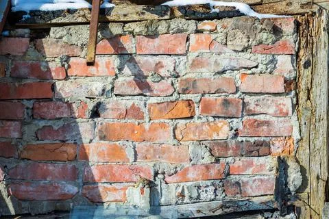 Old collapsed red brick wall with rotten and burned wood beams Stock Photos