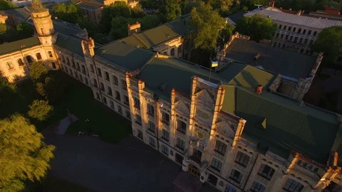 Old colledge on the background of the city at sunset aerial Stock Footage 104709358