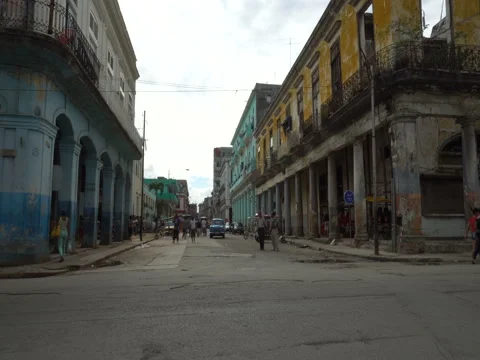 Old colonial dilapidated buildings with columns near the road in Havana Stock Footage 71140801
