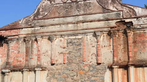 Old colonial facade with crumbling plaster and exposed brick revealing a rough Stock Footage 340598187