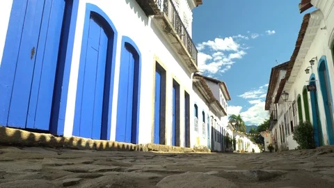 Old Colonial rocks in street with nice houses in Paraty, Brazil Stock Footage