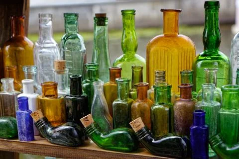 Old colored empty glass bottles are scarce Stock Photos