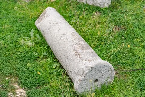 Old column on the grass Stock Photos