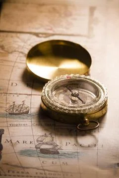 Old compass on ancient map. A compass with the antique image of a direction Stock Photos
