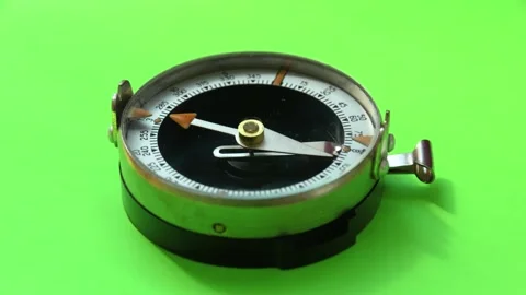Old compass on green background. Vintage compass indicating north Stock Footage 248896687