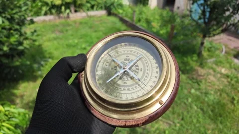 Old compass in hands. Man using compass to find location. Close-up travel concep Stock Footage 311506478