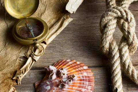 Old compass, rope and shell Stock Photos