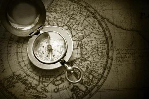 Old compass on vintage map Stock Photos