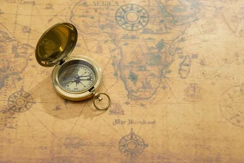 Old compass on vintage map Stock Photos