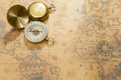 Old compass on vintage map Stock Photos