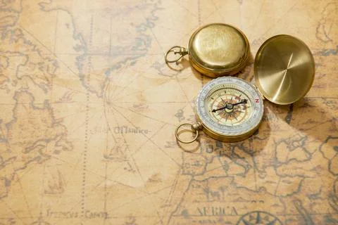 Old compass on vintage map Stock Photos