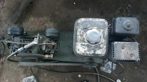 An old compressor machine in the workshop that is worn and dirty Stock Photos