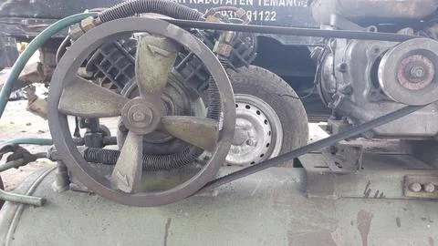 An old compressor machine in the workshop that is worn and dirty Stock Photos
