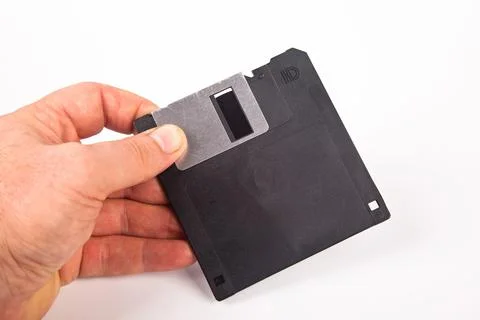 Old computer and data storage technology, hand heldblack magnetic floppy disk Stock Photos