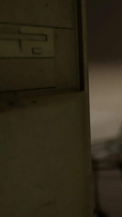 Old computer case sits alone in a dimly lit room near wooden floor Stock Footage 334182792