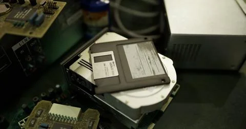 Old computer hardware and floppy disk on a workbench in a workshop Stock Illustration