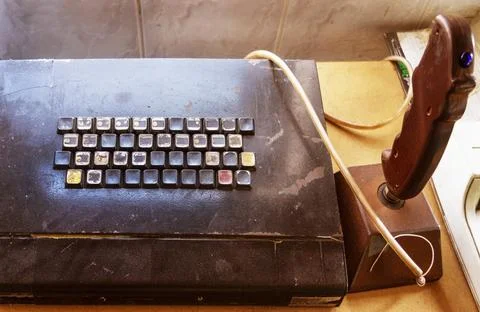Old computer keyboard and game joystick. The first keyboards and joysticks .. Stock Photos